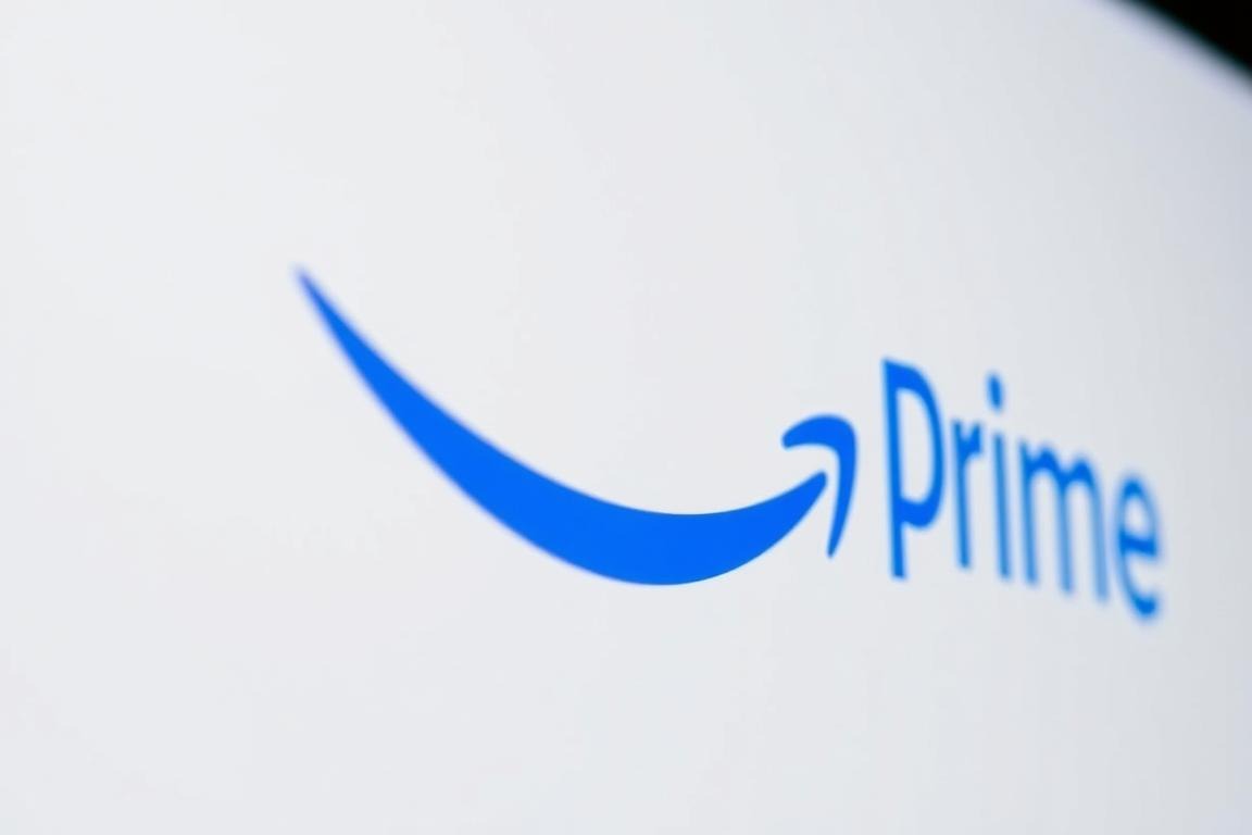 A close-up view of the Amazon Prime logo, prominently displayed on a sleek, minimalist background. The logo's distinctive smile-shaped arrow is rendered in a vibrant, eye-catching blue, contrasting sharply against a clean, white backdrop. The overall composition evokes a sense of professionalism, reliability, and the ubiquitous presence of Amazon's Prime service in the digital landscape. The lighting is soft and diffused, creating a subtle, yet impactful visual. The camera angle is slightly elevated, giving the logo an authoritative, commanding presence within the frame.